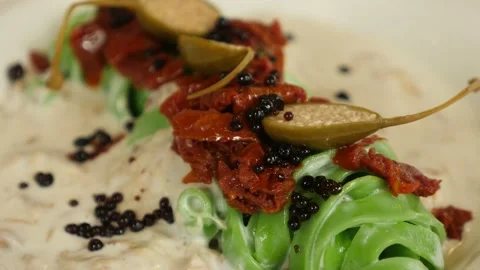 Restaurant dish - original serving of green noodles with sun-dried tomatoes and  Stock Footage 239945592