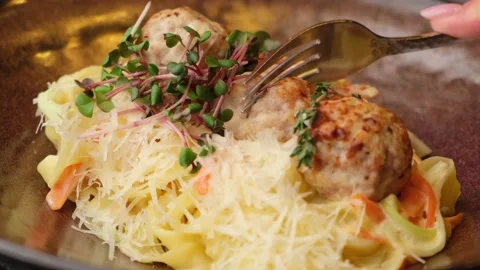 Restaurant dish. pasta with round cutlets in pork sauce. Tasty dish. close-up Stock Footage 149917419