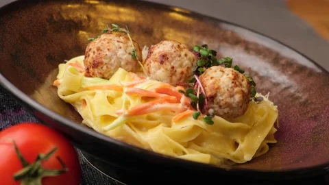Restaurant dish. pasta with round cutlets in pork sauce. Tasty dish. close-up. Stock Footage 150053706