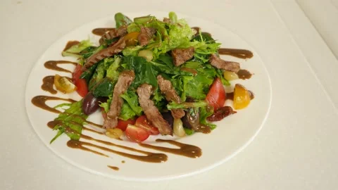 Restaurant dish - vegetable mix with tender veal meat Stock Footage 239945620