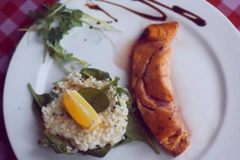 Restaurant feed. Salmon with risotto. Fish and rice Fish with lemon. Dish in  Stock Photos