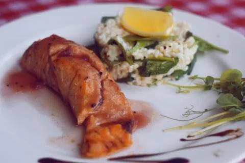 Restaurant feed. Salmon with risotto. Fish and rice Fish with lemon. Dish in  写真素材
