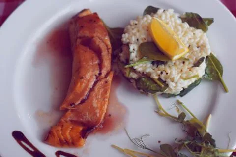 Restaurant feed. Salmon with risotto. Fish and rice Fish with lemon. Dish in  写真素材
