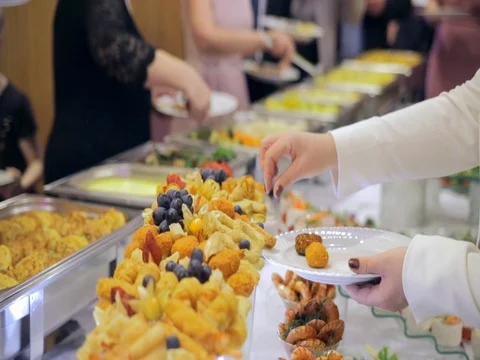 Restaurant guests select food from a buffet Stock Footage 75562857