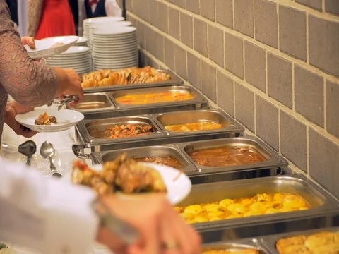 Restaurant guests select food from a buffet Stock Footage 82448324