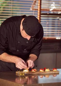 Restaurant hotel private chef preparing making canapes starters snacks Stock Photos