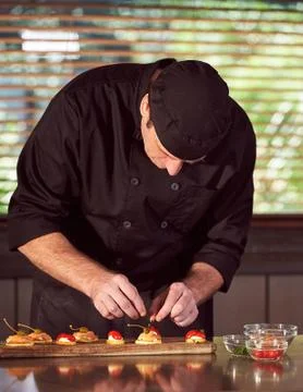 Restaurant hotel private chef preparing making canapes starters snacks Stock Photos