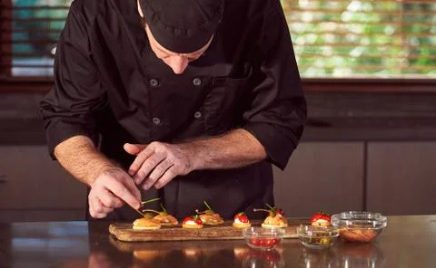 Restaurant hotel private chef preparing making canapes starters snacks Stock Photos