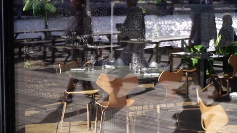 Restaurant interior behind glass. Table in a restaurant. Round table setting. Stock Footage 271610129