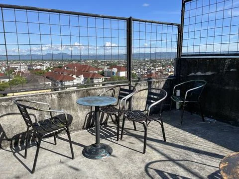 Restaurant interior featuring metal table and chair with panoramic view Stock Photos