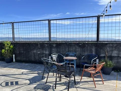 Restaurant interior featuring metal table and chair with panoramic view Stock Photos