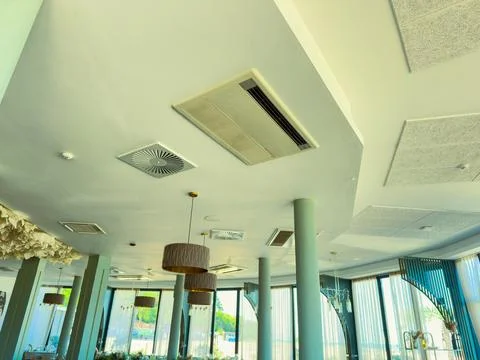 Restaurant interior shows ceiling design with air conditioning, lights, and.. Stock Photos