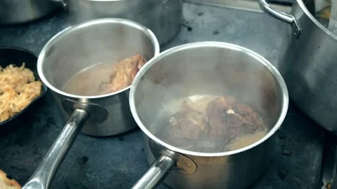 Restaurant kitchen. Beef and pork are cooked in a saucepan. Meat stew. Close ap. Stock Footage 171682572