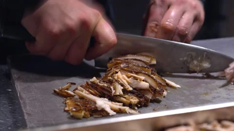Restaurant kitchen, chef cuts boiled meat for salad with a knife. Beef, pork Stock Footage 171682365