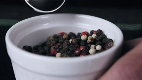 Restaurant kitchen, close up of chef scooping black pepper from a bowl Stock Footage 132779919