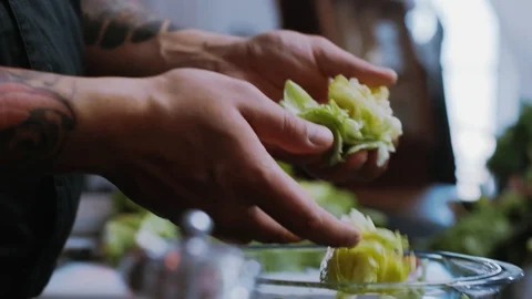 In restaurant kitchen hands man chef hold cook shares the cabbage cutting salad Stock Footage 100303346