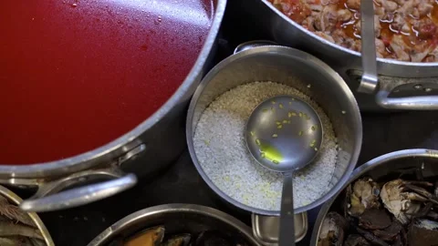 Restaurant kitchen preparing rice and seafood dishes Vídeos de archivo 300209826