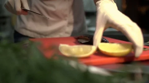 Restaurant kitchen. Professional chef is cooking fish. Close-up. Stock Footage 84037226