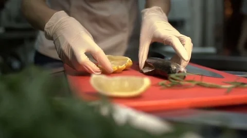Restaurant kitchen. Professional chef is cooking fish. Close-up. Stock Footage 84037265
