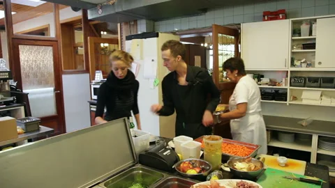 Restaurant Kitchen Staff Preparing Dishes and Coordinating Food Service Stock Footage 343724519