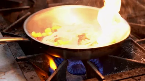 Restaurant kitchen stove saute' pan  flame up close up Stock Footage 156044658