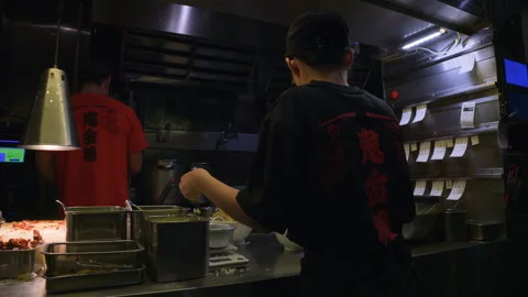Restaurant Kitchen Workers Prepare Bowls of Food at Stainless Steel Counter Stock Footage 344046911