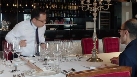 Restaurant manager calculating the costs for a client Stock-Footage 333216336