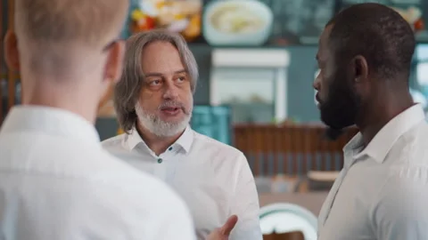 Restaurant manager instruct waiters before opening. Realtime Stock Footage 233928338