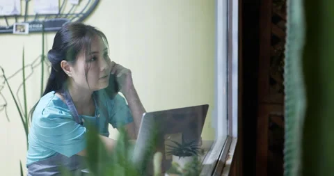 Restaurant manager surfing the web and conversing on her smartphone Stock Footage 172280840