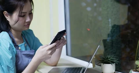 Restaurant manager surfing the web and conversing on her smartphone Stock Footage 172281167