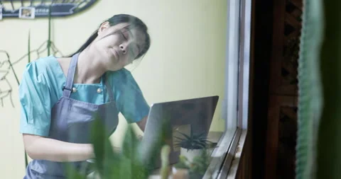 Restaurant manager surfing the web . viewed through glass with reflections. Stock Footage 172280817
