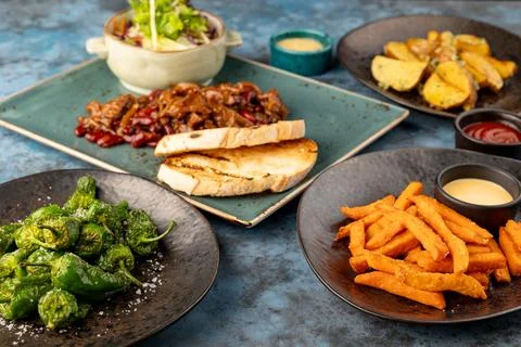 Restaurant menu set. meat and beans, salad, potatoes, croutons. on blue grey Stock Photos