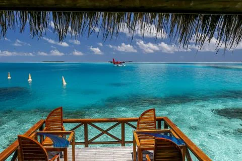 Restaurant in the ocean with a view of the parked small seaplane. Stock Photos