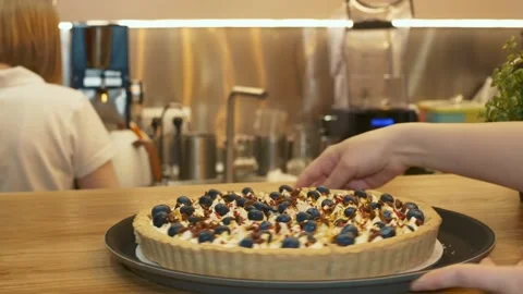 In a restaurant or cafe, behind the bar, the barista stands with his back and Stock Footage 151247548