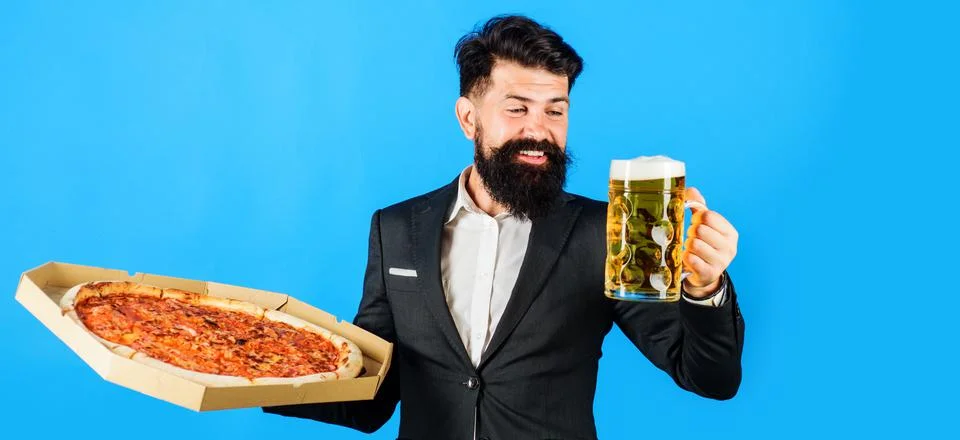 Restaurant or pizzeria. Smiling man with pizza in box and mug of beer. Pizza  Stock Photos