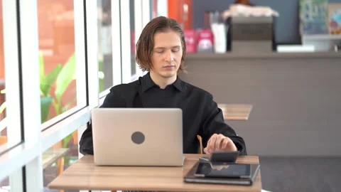 Restaurant owner doing accounting with calculator and computer laptop in co.. Stock Footage 242992330