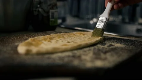 In the restaurant, professional chef prepares pizza, adds sauce to the dough. Stock Footage 221271077