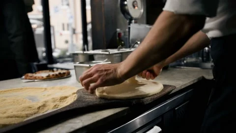 In Restaurant Professional Chef Preparing Pizza, Kneading Dough, flouring it. Stock Footage 221271993