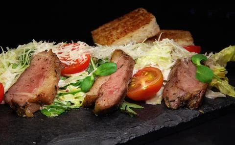 Restaurant serving snacks on the board - fried bread, meat, finely chopped Stock Photos
