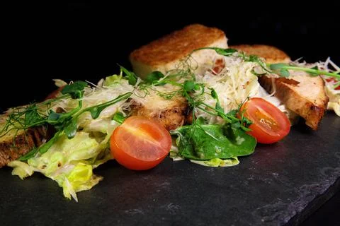Restaurant serving snacks on the board - fried bread, meat, finely chopped Stock Photos