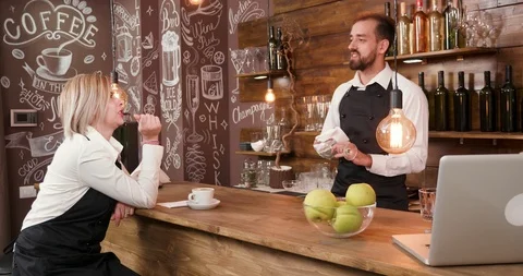 Restaurant staff after a work day relaxing and socialising at the bar Stock Footage 104862715