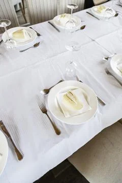 Restaurant table to detail of a dining table, dishes and silverware for food Stock Photos
