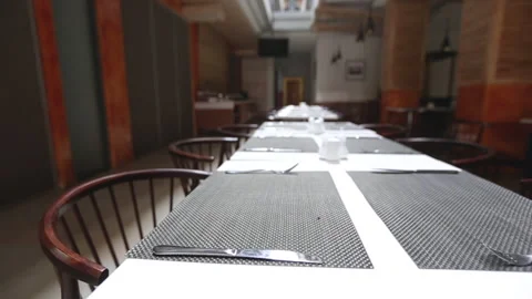 A restaurant table in a hotel with a pair of spoons and forks Stock Footage 147135803