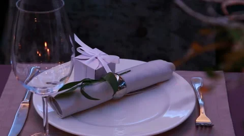 Restaurant table layout with nice presents for a romantic dinner Stock Footage 68888649
