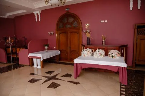 Restaurant, a table in red colors, a large room with a door Stock Photos