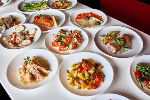 Restaurant Table Setting with Delicious Dishes Stock Photos