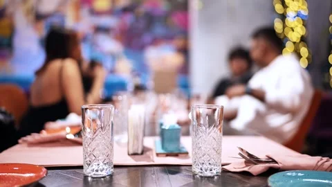 Restaurant table setting with empty glasses on dinner during evening dining Stock Footage 326446420
