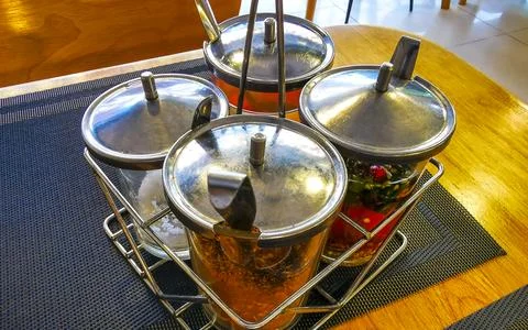Restaurant table setting with sauces spices napkins salt pepper shakers Tha.. Stock Photos