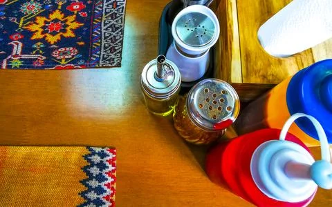 Restaurant table setting with sauces spices napkins salt pepper shakers Tha.. Stock Photos