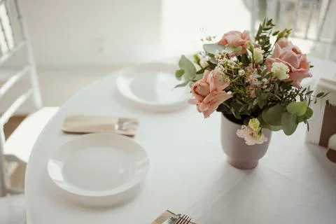 Restaurant table setting with white plate and cutlery Stock Photos